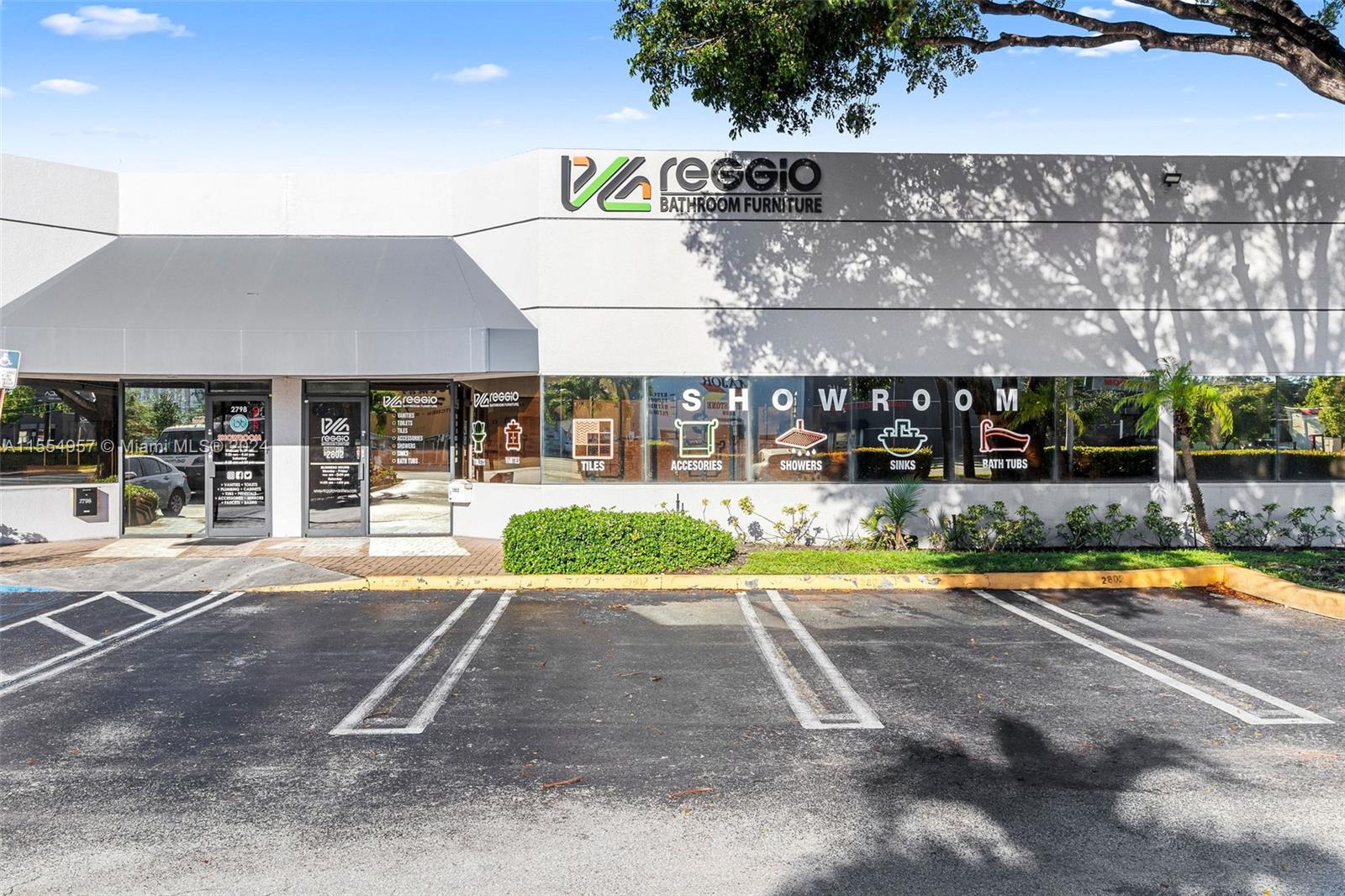 The exterior of a commercial building features a Reggio Bathroom Furniture showroom with large windows — Bath Vanities/Accessories and Flooring, Doral FL 33122, DORAL, FL