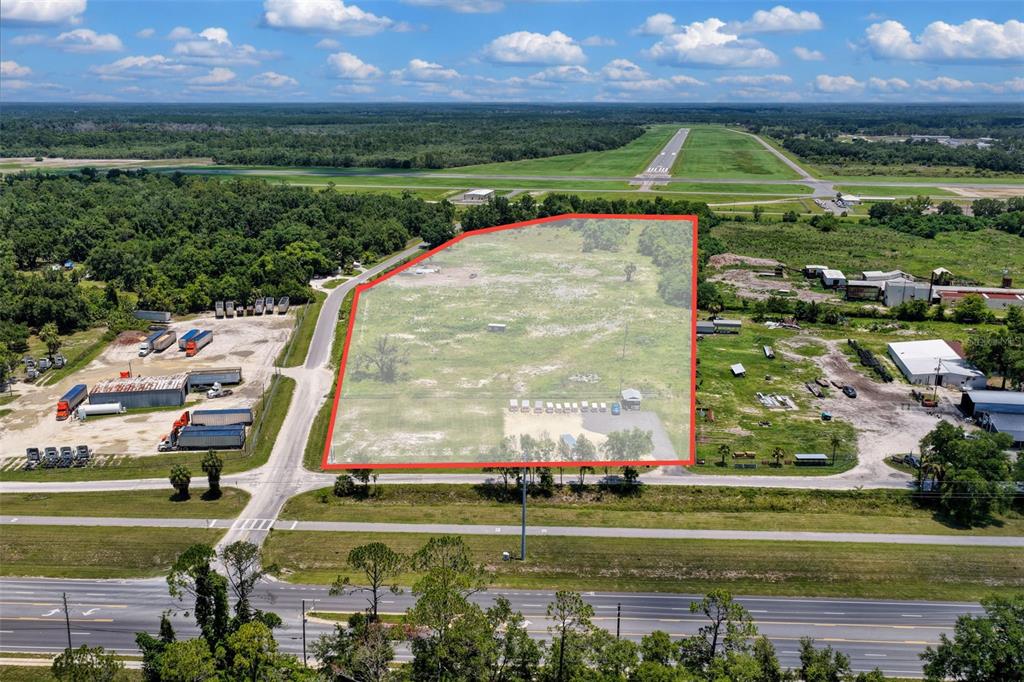 An aerial view shows a vacant, rectangular lot outlined in red next to a highway — 86 NE 170TH STREET, CROSS CITY, FL