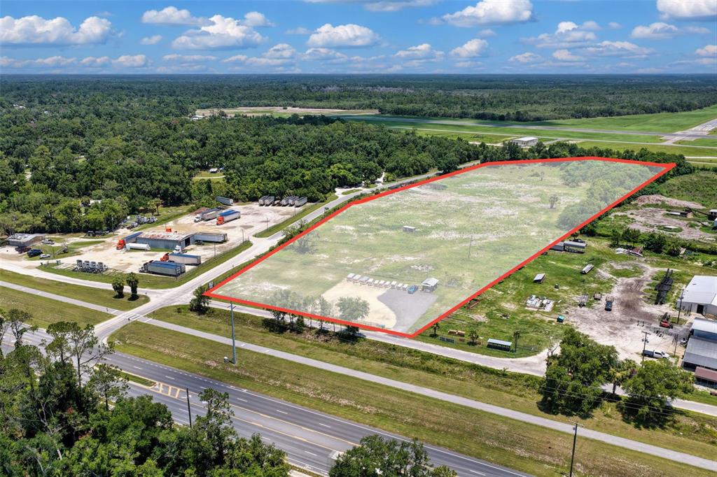 An aerial view shows a large, rectangular vacant lot outlined in red next to a highway — 86 NE 170TH STREET, CROSS CITY, FL