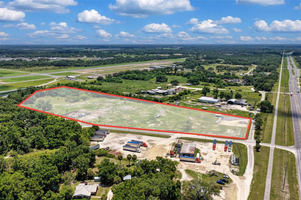 An aerial view shows a large, rectangular plot of land outlined in red near a highway — 86 NE 170TH STREET, CROSS CITY, FL