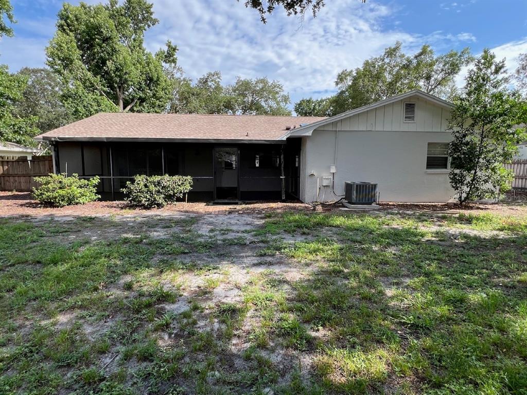A single-story house with a white garage, gray roof, and a concrete driveway — 8511 SHADY GLEN DRIVE, ORLANDO, FL