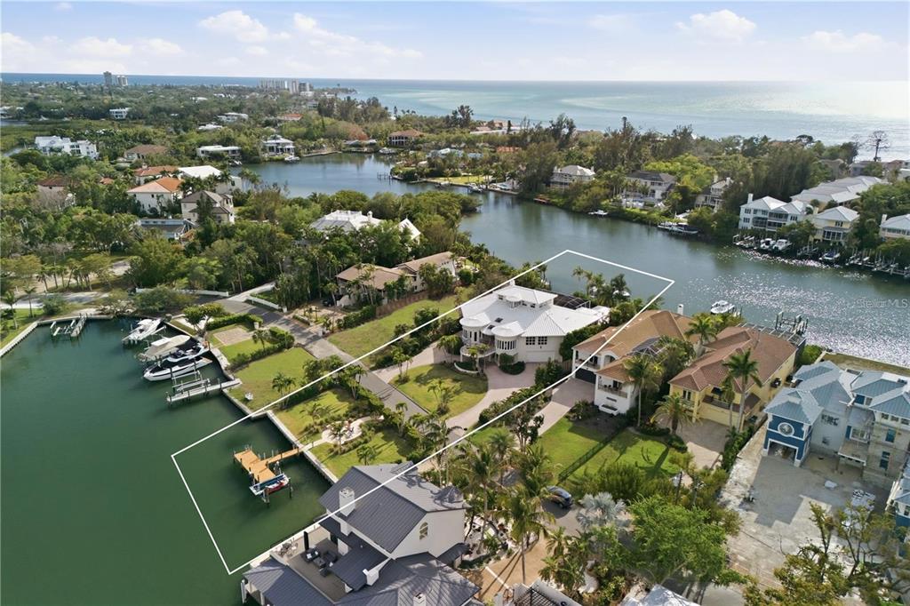 An aerial view of a waterfront house with a private dock and a large lawn — 4034 ROBERTS POINT ROAD, SARASOTA, FL