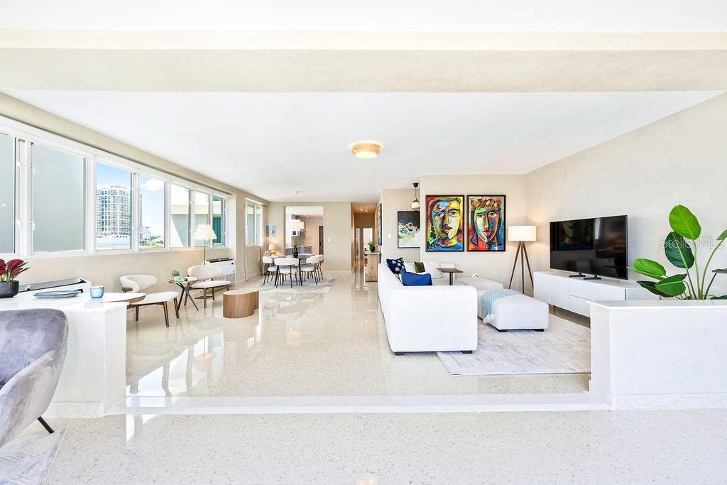 A bright, open-concept living and dining area features white tile floors and modern furniture — 57 ASHFORD AVENUE UNIT 5, SAN JUAN, PR