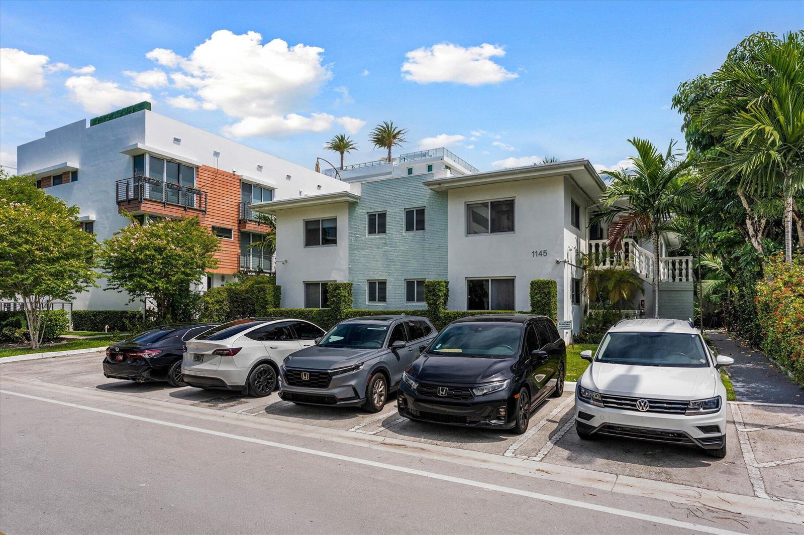 A two-story apartment building with five parked cars in front under a blue sky — 1145 101 St # 1, Bay Harbor Islands FL 33154, BAY HARBOR ISLANDS, FL