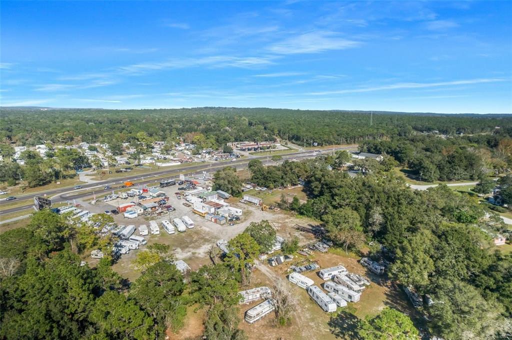An aerial view shows a large lot filled with numerous parked RVs and trailers — 16076 CORTEZ BOULEVARD, BROOKSVILLE, FL