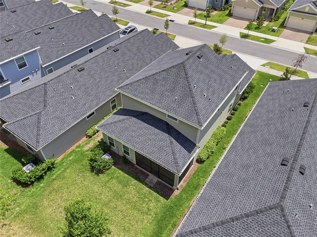 An aerial view shows the dark shingled roofs of several suburban houses and backyards — 2208 NW 89TH WAY, GAINESVILLE, FL