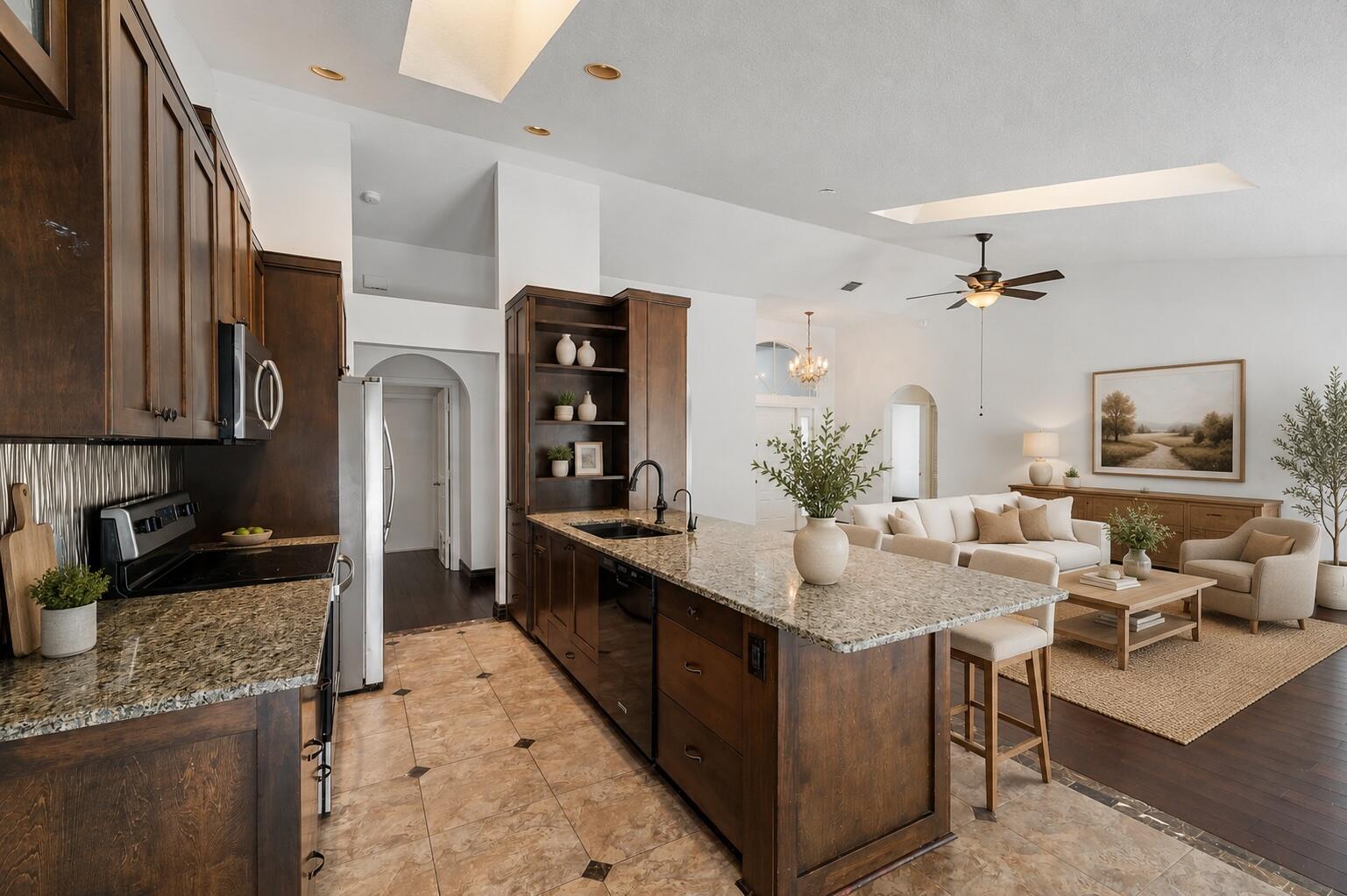 A kitchen with dark wood cabinets and granite countertops opens into a living room area — 11480 150th Court N, FL 33478, FL