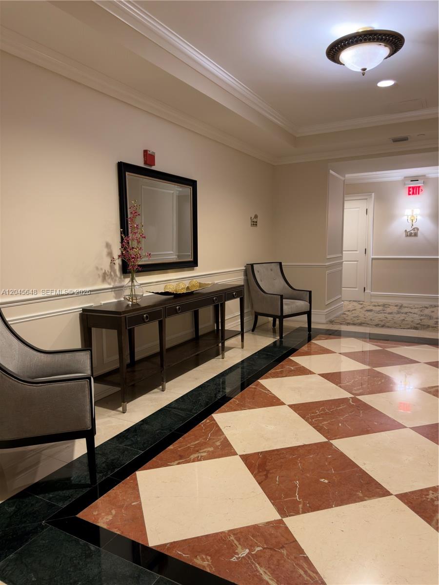 A formal lobby features a checkered marble floor, a console table, and two upholstered chairs — 16100 Emerald Estates Dr # 281, Weston FL 33331, WESTON, FL