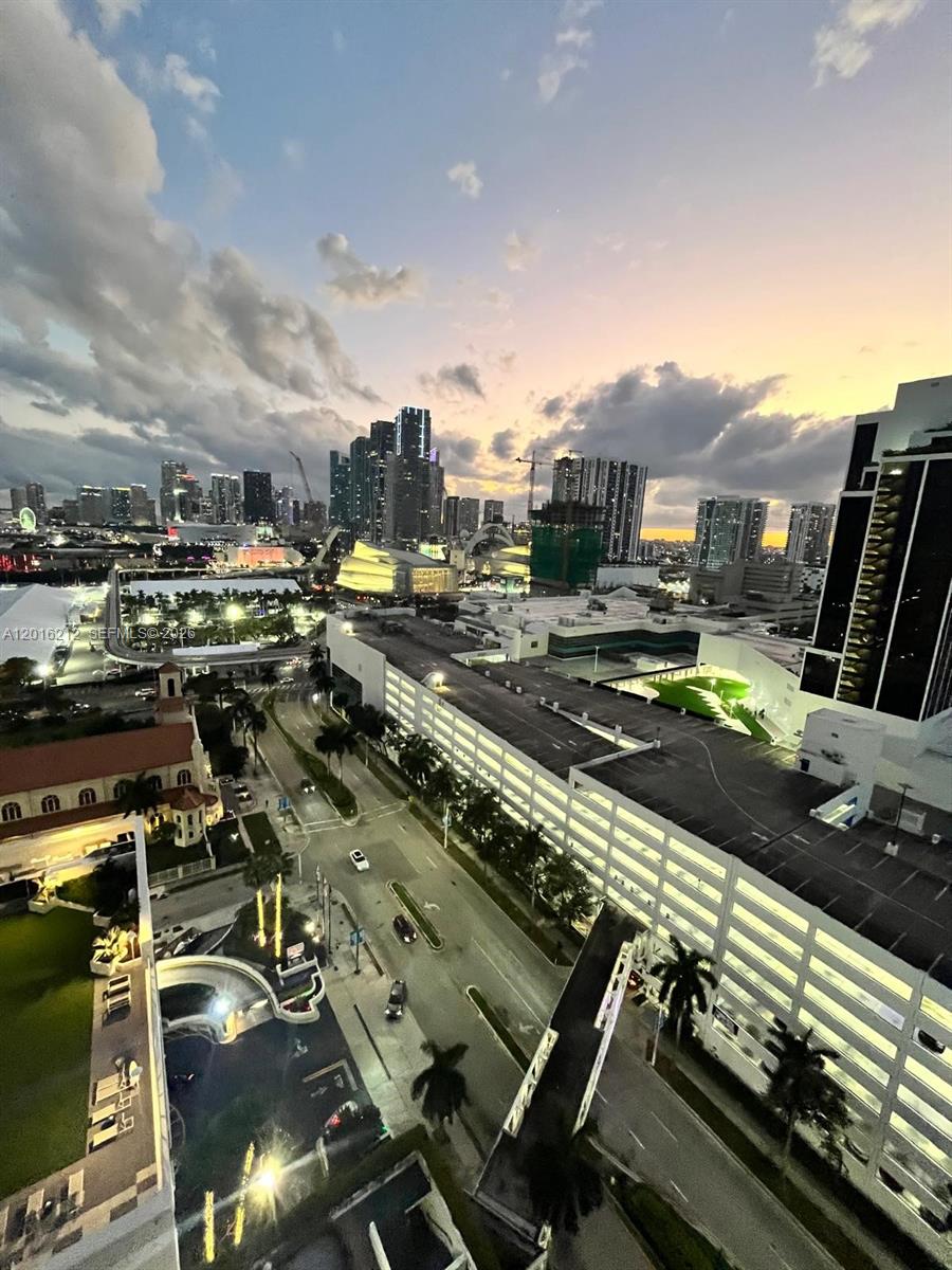 An elevated view of a city skyline at sunset featuring a parking garage and street — 1717 N Bayshore Dr # 2453, Miami FL 33132, MIAMI, FL