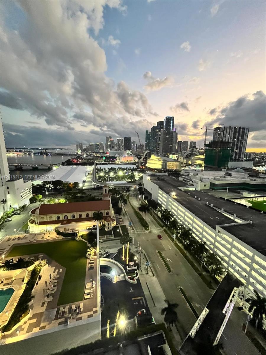 An elevated view of a city skyline at dusk with a church and parking garage — 1717 N Bayshore Dr # 2453, Miami FL 33132, MIAMI, FL