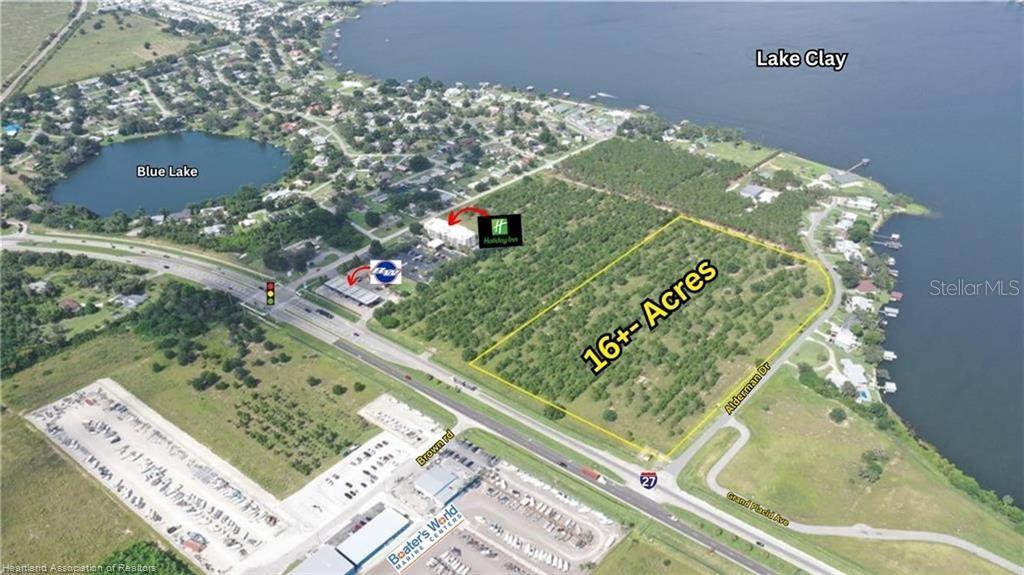 This aerial map shows a large, undeveloped plot of land near a lake and highway — 705 US 27 N, LAKE PLACID, FL