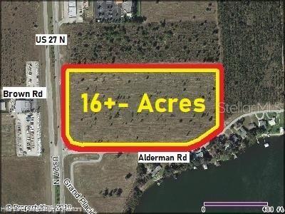 This aerial map shows a vacant, rectangular plot of land highlighted in yellow and red — 705 US 27 N, LAKE PLACID, FL