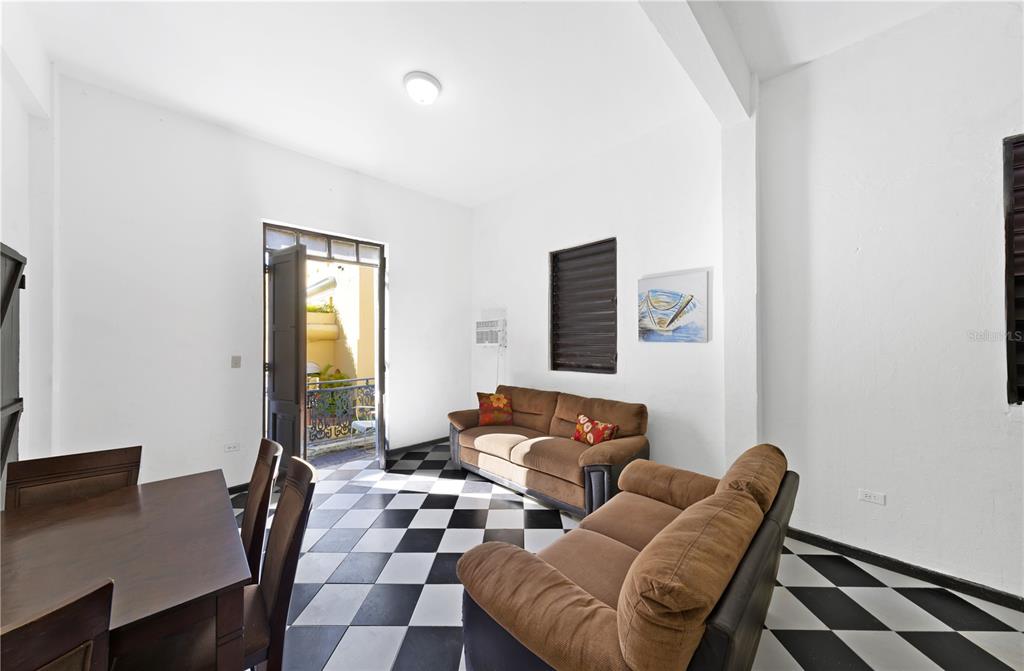 A living and dining area features black and white checkered tile floors and two sofas — 103 CRISTO STREET, SAN JUAN, PR