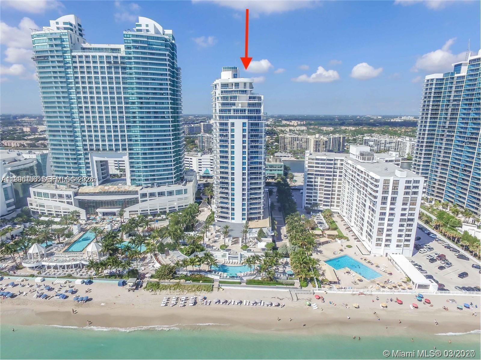 An aerial view shows a tall white residential tower on a sandy beach — 3535 S Ocean Dr # 1006, Hollywood FL 33019, HOLLYWOOD, FL