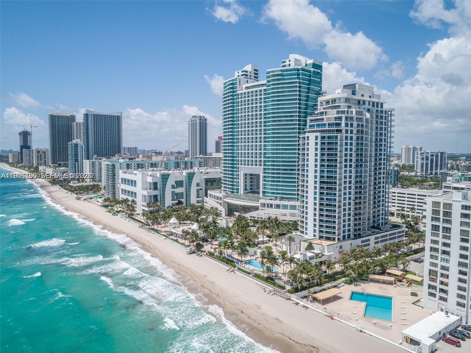 An aerial view of a beachfront resort with multiple high-rise towers and swimming pools — 3535 S Ocean Dr # 1006, Hollywood FL 33019, HOLLYWOOD, FL
