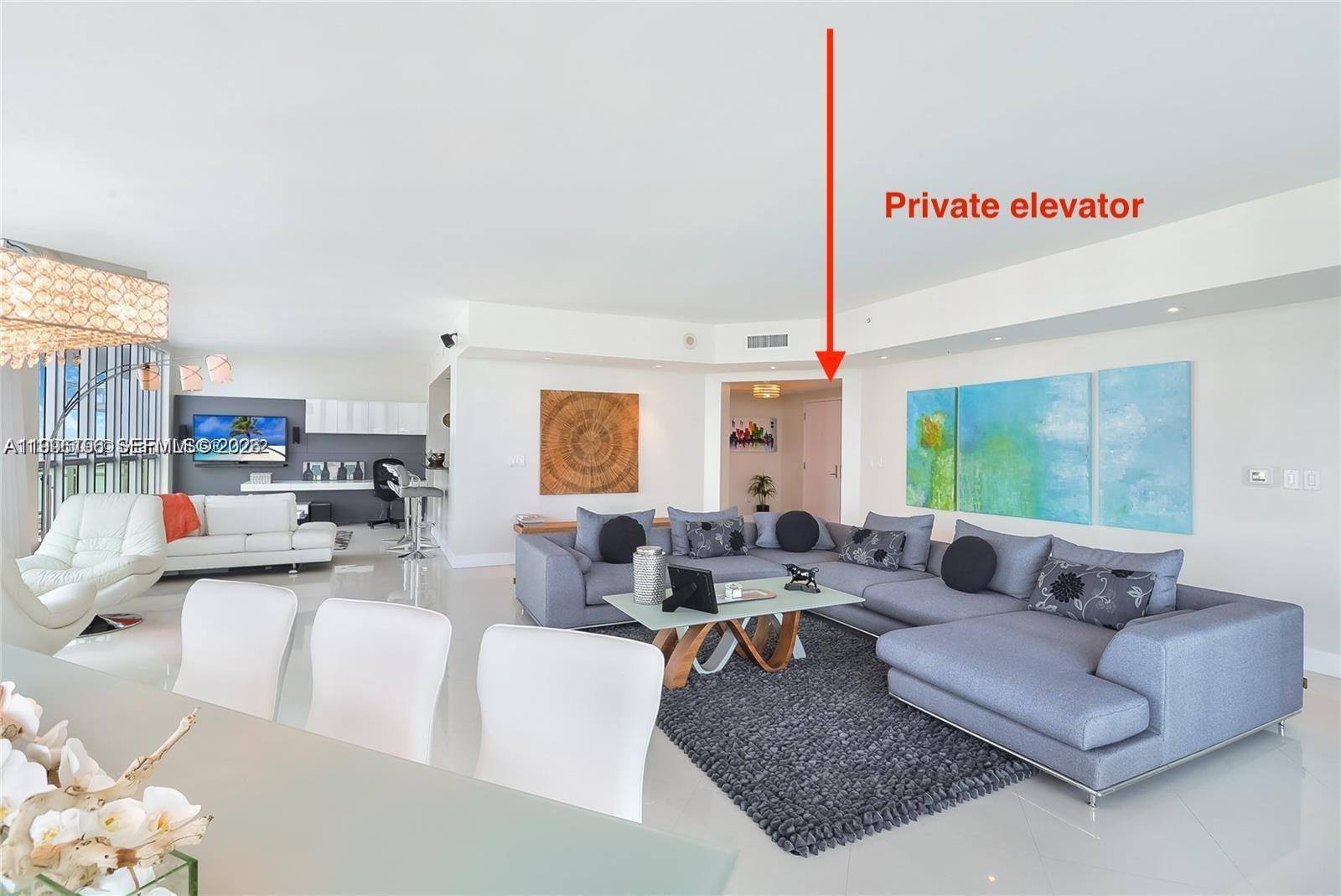 A spacious, modern living room features white tile floors, a gray sectional, and an elevator — 3535 S Ocean Dr # 1006, Hollywood FL 33019, HOLLYWOOD, FL