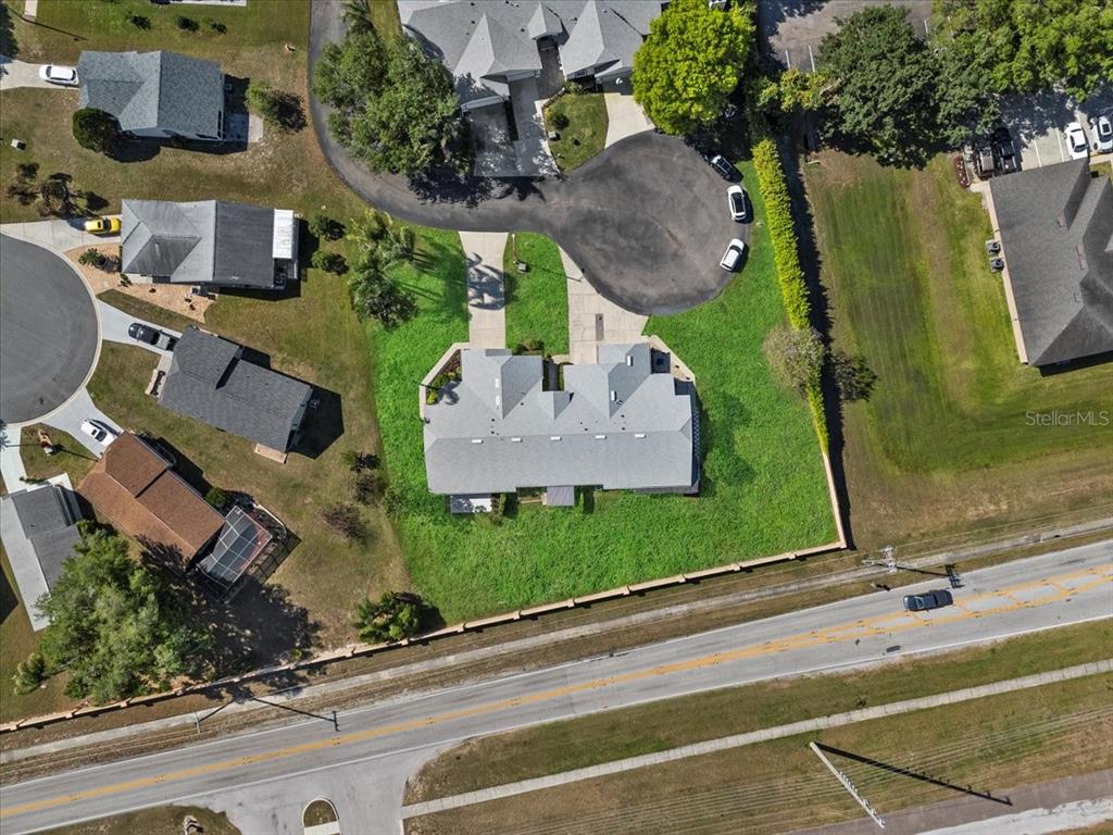 An aerial view shows a residential duplex with a shared driveway and a large backyard — 6381 EGRET DRIVE UNIT 19, LAKELAND, FL