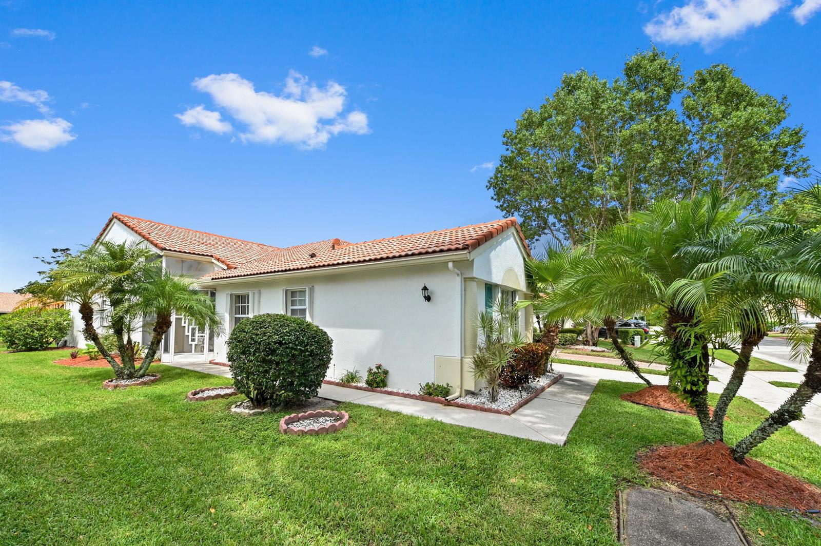 A white, single-story house with a red tile roof and palm trees in the yard — 6077 Lake Hibiscus Drive, Delray Beach FL 33484, DELRAY BEACH, FL