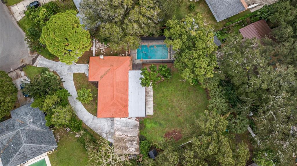 An aerial view shows a house with an orange roof, a pool, and a large yard — 2608 OAKWOOD DRIVE, LARGO, FL