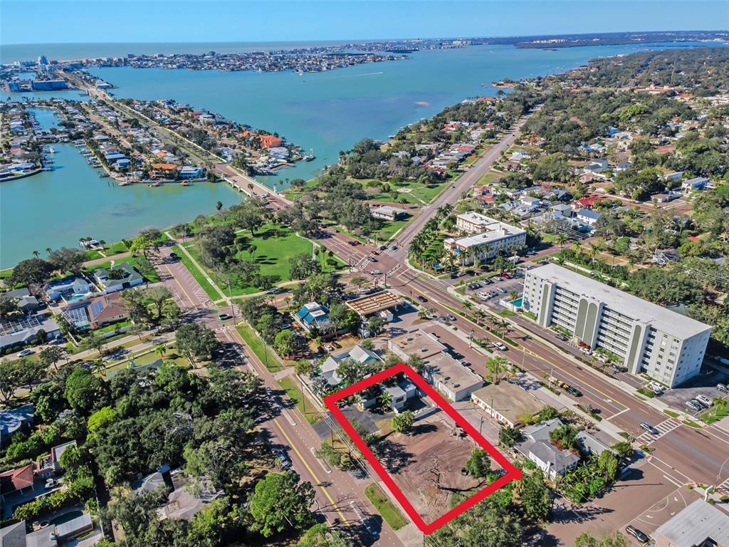 An aerial view highlights a vacant rectangular lot with a small building in a neighborhood — 7301 1ST AVENUE S, ST PETERSBURG, FL
