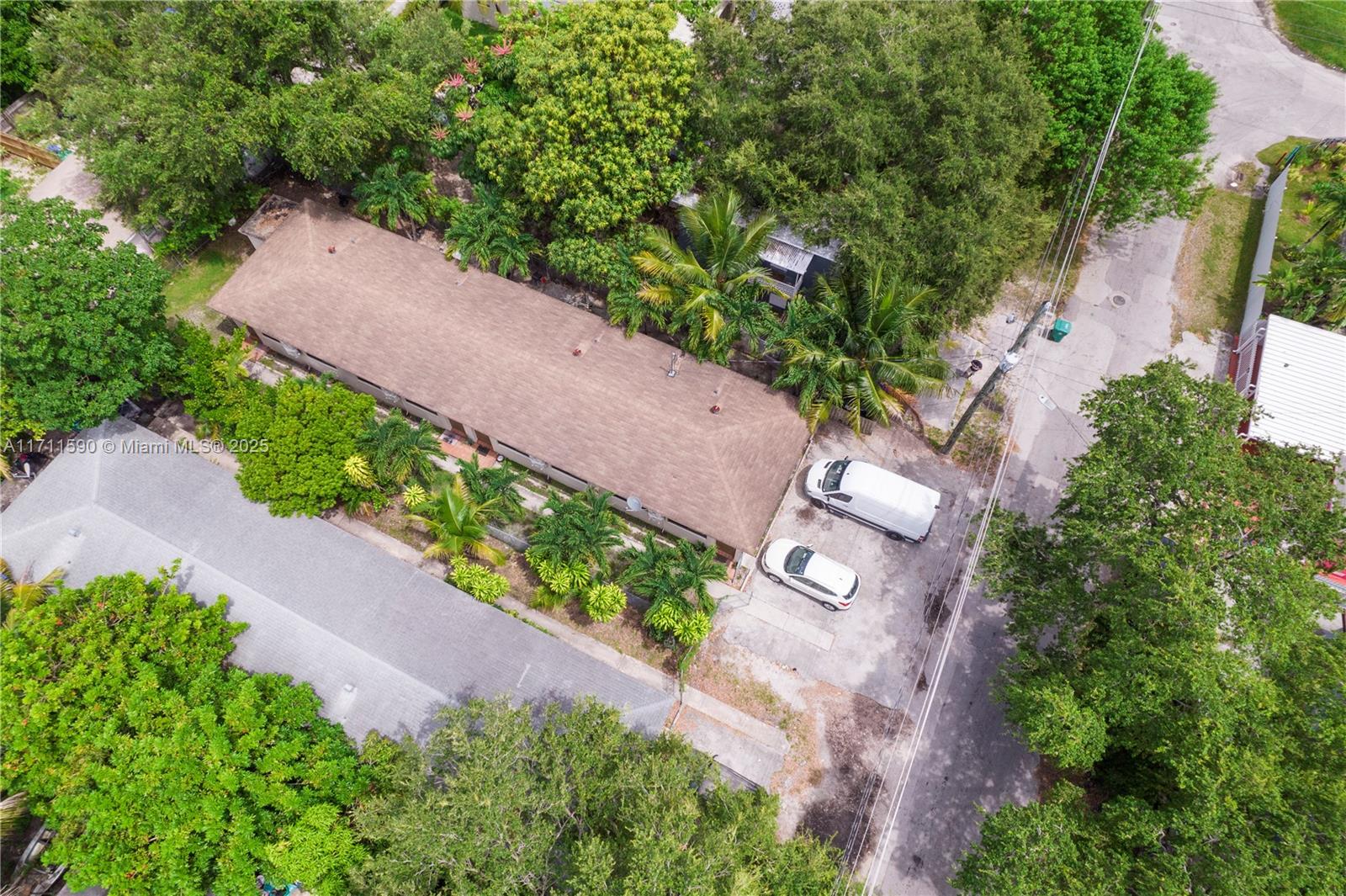An aerial view shows a long, single-story building with a brown roof and two parked vehicles — 5520 NE 1st Ct, Miami FL 33137, MIAMI, FL