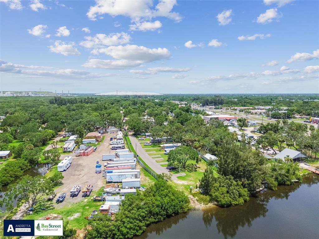 An aerial view shows a mobile home park with trailers and boats near a lake — 11224 RESTWOOD DRIVE, GIBSONTON, FL