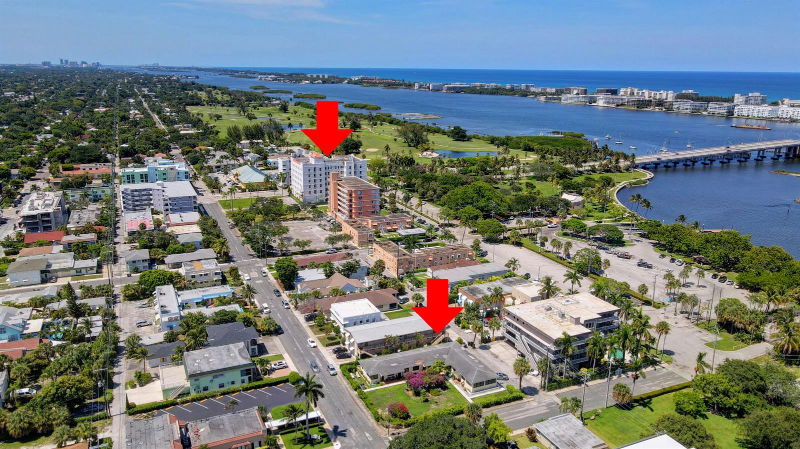 An aerial view shows two red arrows pointing to multi-story residential buildings in a coastal neighborhood — 130 S Lakeside 1 Drive, FL 33460, FL