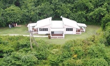An aerial view shows a white, single-story house surrounded by dense green vegetation — End of Road CAM PLAYA TAMARINDO, CULEBRA, PR