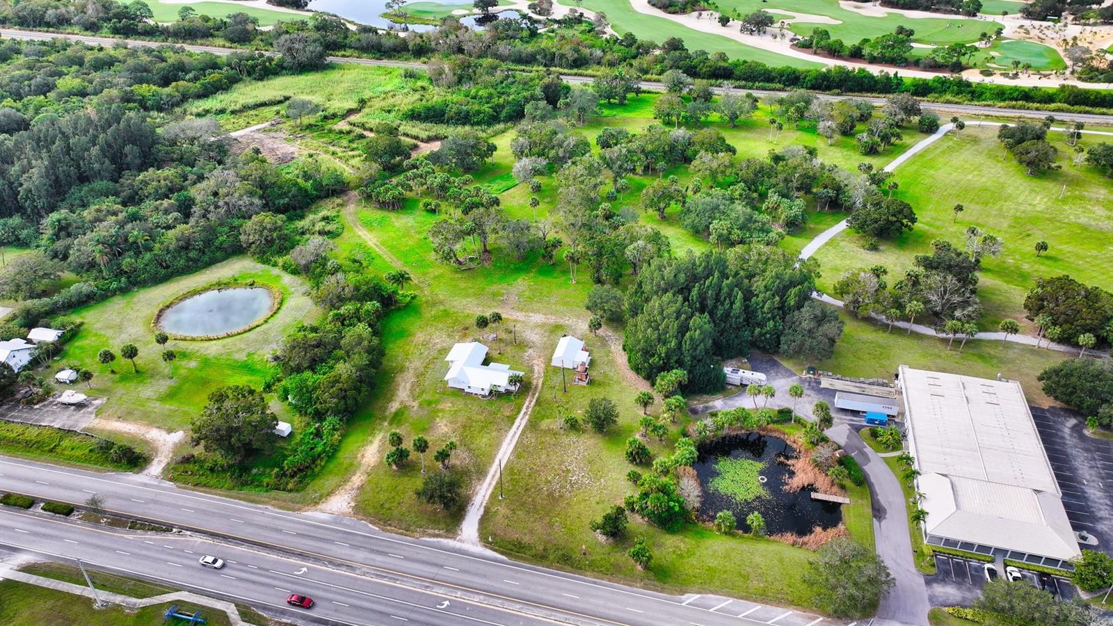 An aerial view shows a property with two houses, two ponds, and a commercial building — 9185 US Highway 1, Sebastian FL 32958, SEBASTIAN, FL