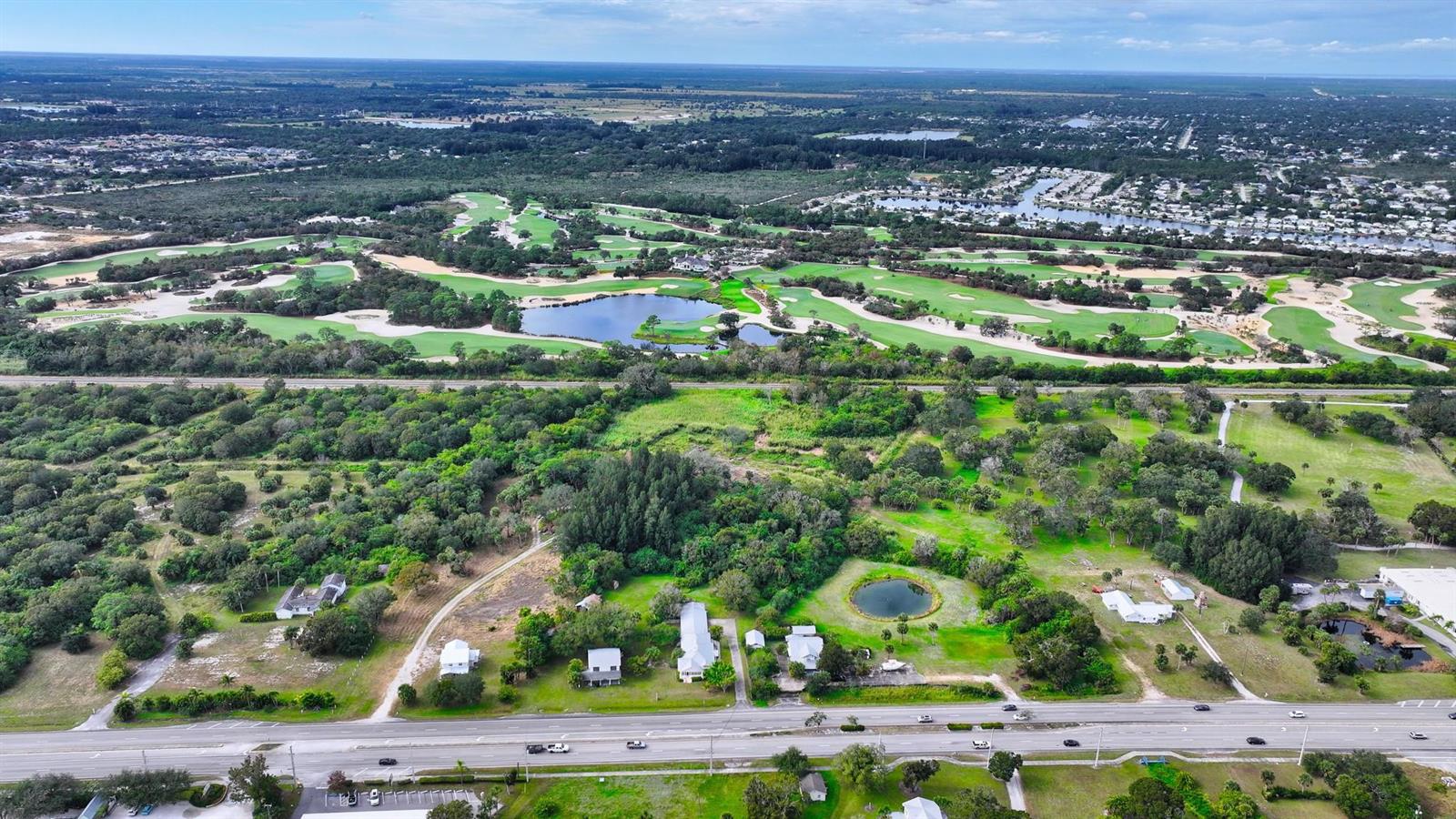 An aerial view shows a rural property with several small buildings near a golf course — 9185 US Highway 1, Sebastian FL 32958, SEBASTIAN, FL