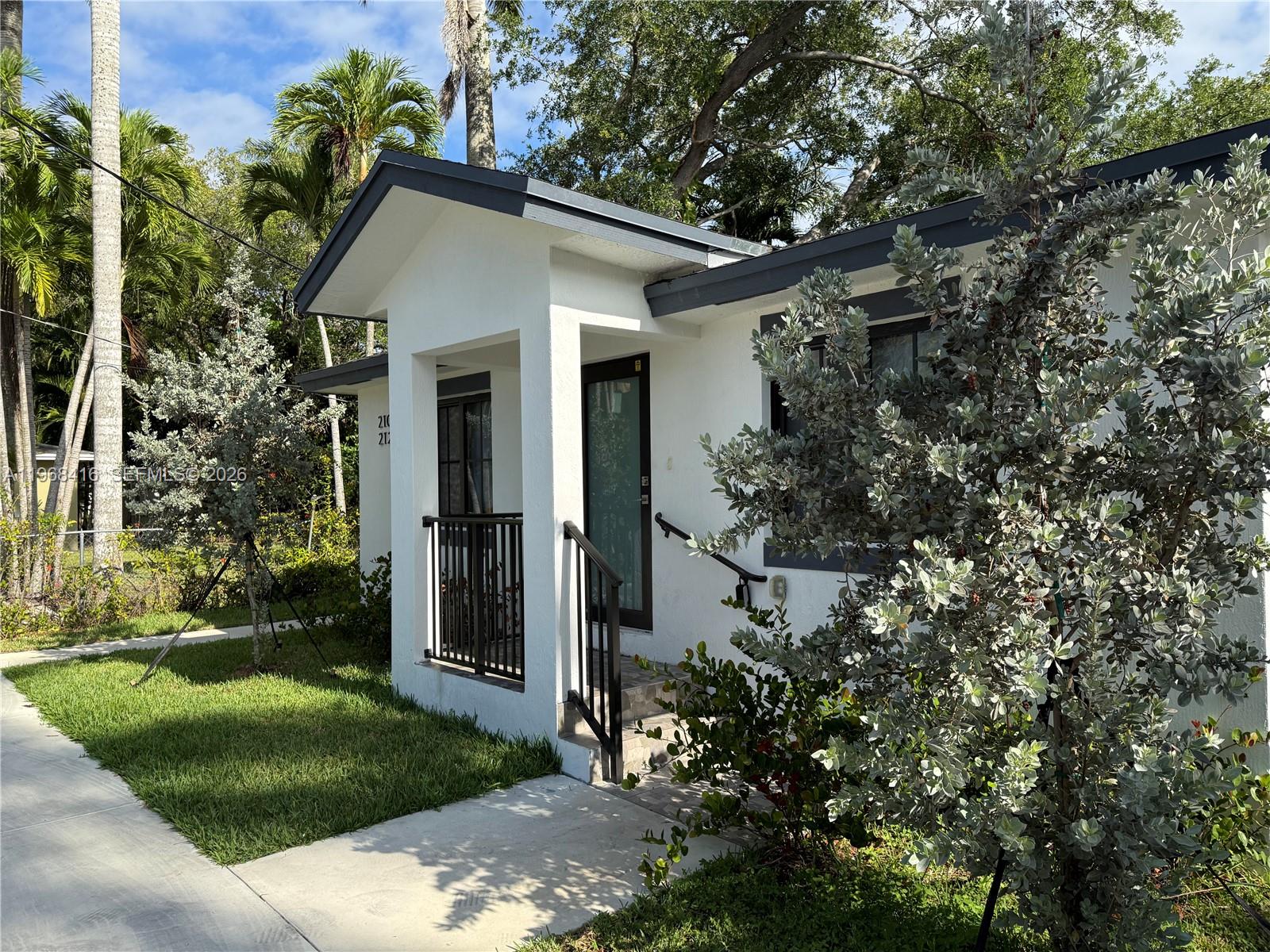 A white house with a dark gray roof and a small covered front porch — 210 SW 3rd St, Florida City FL 33034, FLORIDA CITY, FL