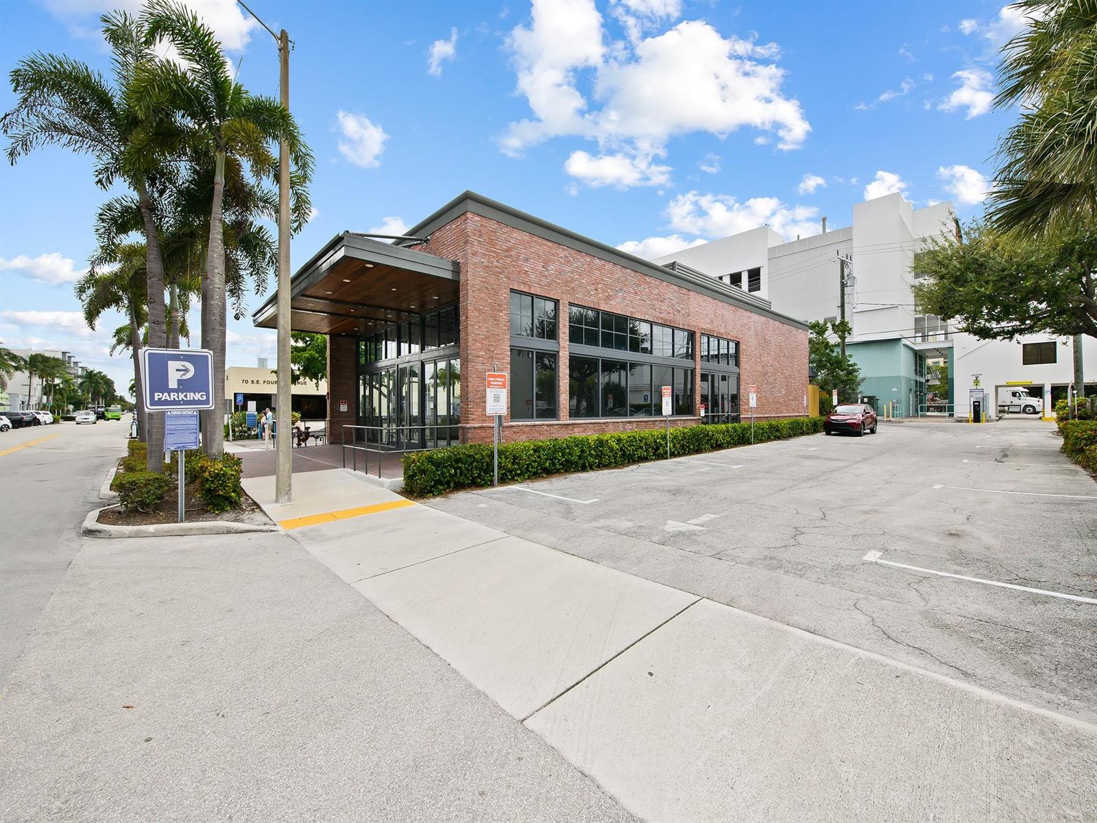 A brick commercial building features a covered entrance and an adjacent paved parking lot — 50 SE 4th Avenue, Delray Beach FL 33483, DELRAY BEACH, FL