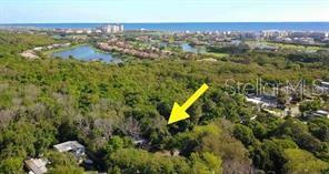 An aerial view shows a wooded lot with a yellow arrow pointing toward the property — 17 SHADY LANE N, PALM COAST, FL