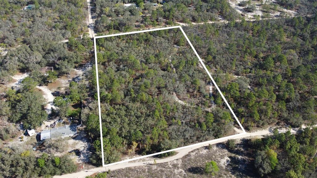An aerial view shows a rectangular, wooded vacant lot outlined in white — 4845 W HERMAN COURT, HOMOSASSA, FL