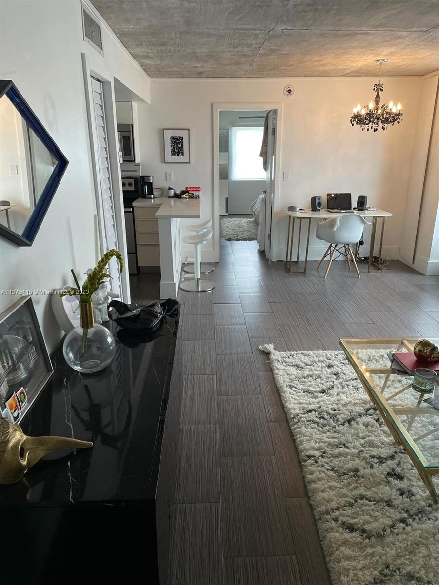 A living area features a kitchen counter, a desk, and a glass coffee table — 753 Michigan Ave # 2E, Miami Beach FL 33139, MIAMI BEACH, FL