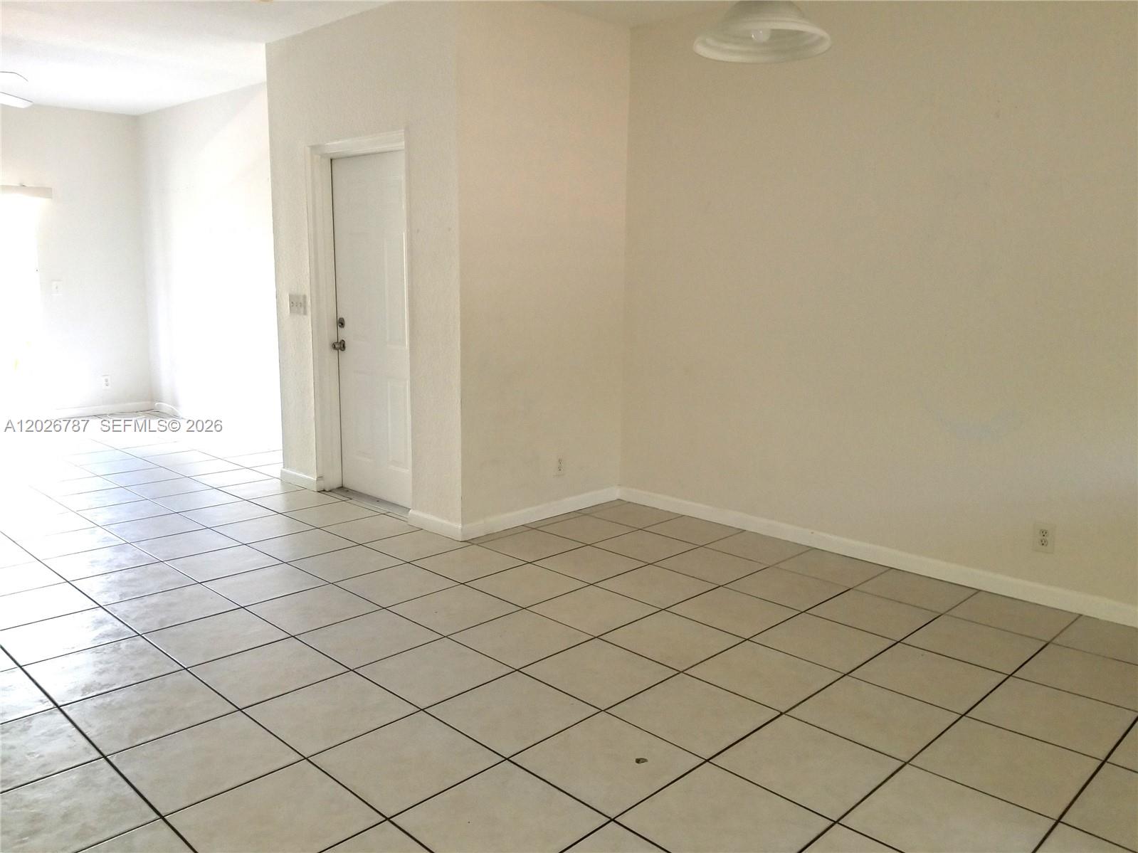 A kitchen features white cabinets, stainless steel appliances, a tiled backsplash, and light-colored tile flooring — 4812 Washington St # 147, Hollywood FL 33021, HOLLYWOOD, FL