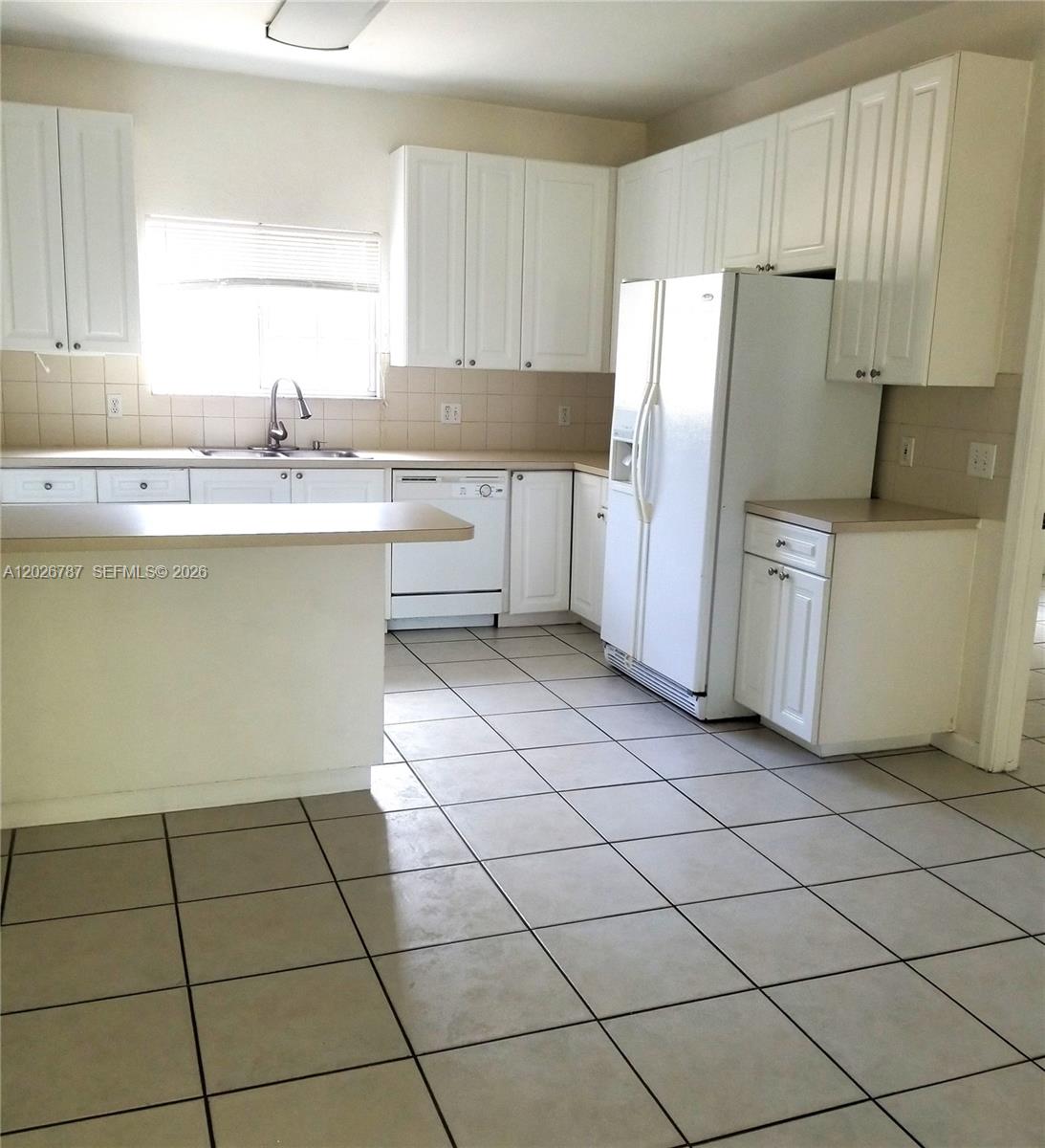 An empty room features white walls, light-colored floor tiles, a ceiling fan, and sliding glass doors — 4812 Washington St # 147, Hollywood FL 33021, HOLLYWOOD, FL