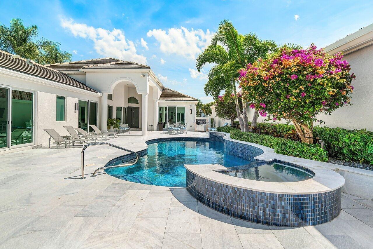 A backyard swimming pool and hot tub with a patio and a house exterior — 3506 NW Clubside Circle, Boca Raton FL 33496, BOCA RATON, FL