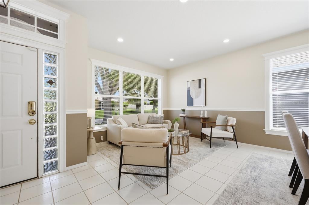 A living room features white tile floors, two-tone walls, and a seating area with chairs — 107 GOLDEN CREST COURT, WINTER SPRINGS, FL