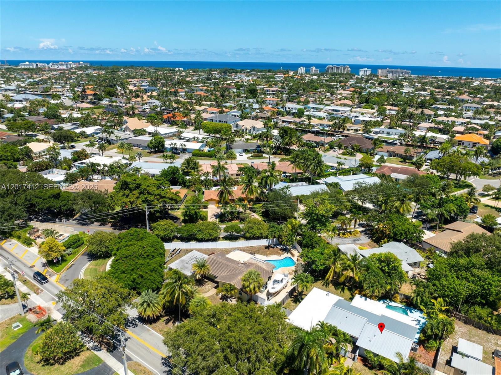 An aerial view shows a residential neighborhood with houses, swimming pools, and palm trees — 4010 NE 22nd Ave, Lighthouse Point FL 33064, LIGHTHOUSE POINT, FL