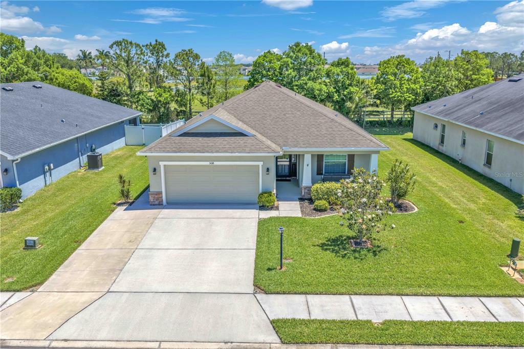 A single-story suburban house with a two-car garage and a front lawn — 5018 33RD AVENUE E, PALMETTO, FL