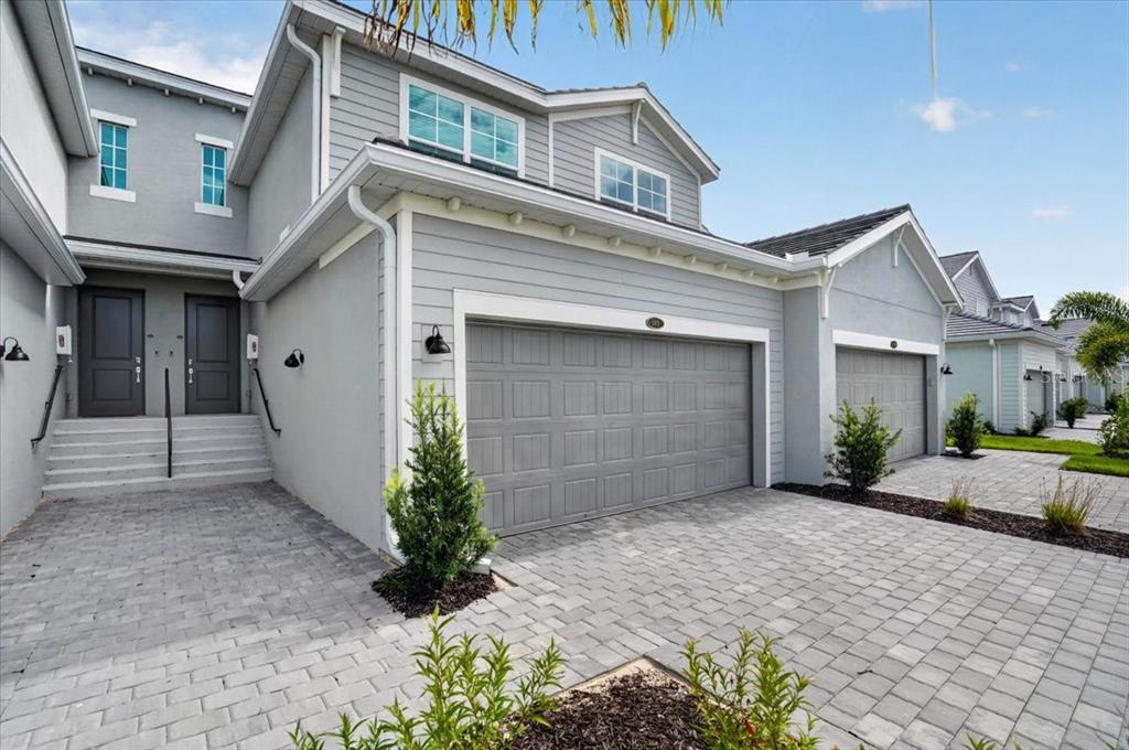 A two-story gray house with a two-car garage and a paved driveway — 19209 CHERRYSTONE WAY UNIT 103, LAKEWOOD RANCH, FL