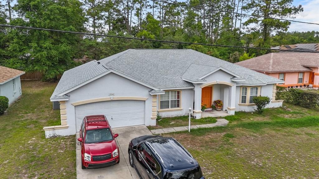 An aerial view of a single-story house with a gray roof and two parked cars — 13536 SW 81ST CIRCLE, OCALA, FL