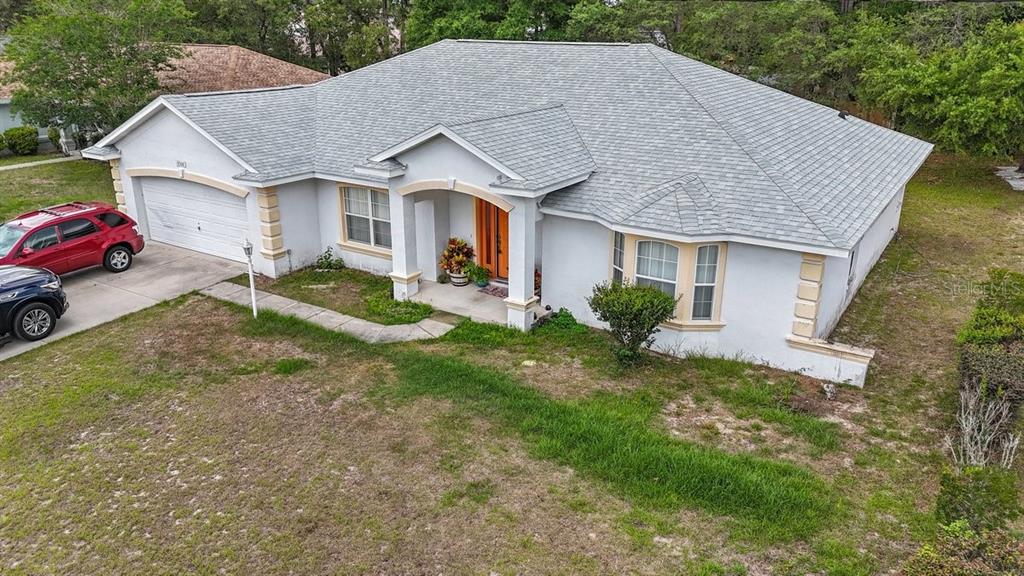 An aerial view of a single-story suburban house with a gray roof and white exterior — 13536 SW 81ST CIRCLE, OCALA, FL