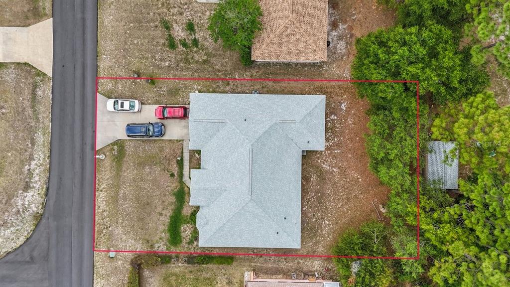 Aerial view of a house with a gray roof, driveway, and surrounding yard — 13536 SW 81ST CIRCLE, OCALA, FL