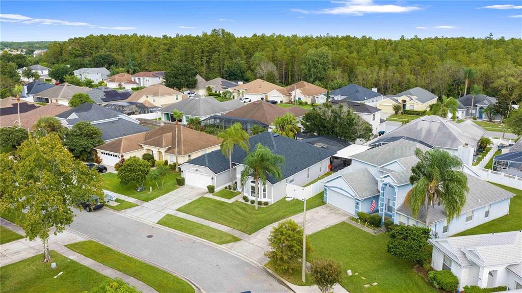 An aerial view shows a suburban neighborhood with single-family homes, manicured lawns, and surrounding trees — 416 BECKY STREET, ORLANDO, FL