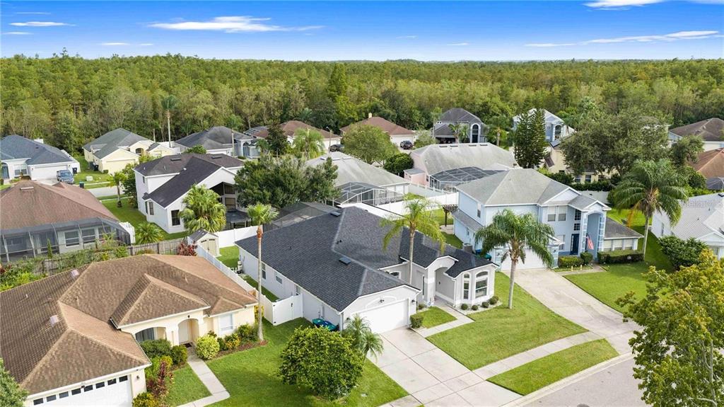 An aerial view shows a suburban neighborhood with several single-family homes and surrounding green trees — 416 BECKY STREET, ORLANDO, FL