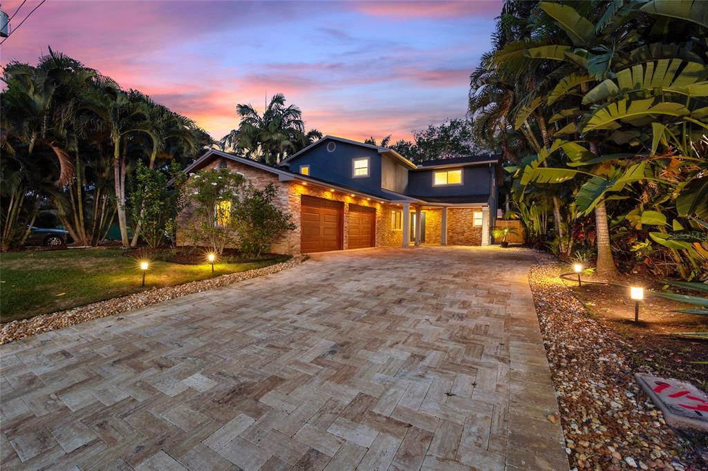 A bathroom features a tiled walk-in shower, a dark wood vanity, and light blue walls — 9545 135TH STREET, SEMINOLE, FL