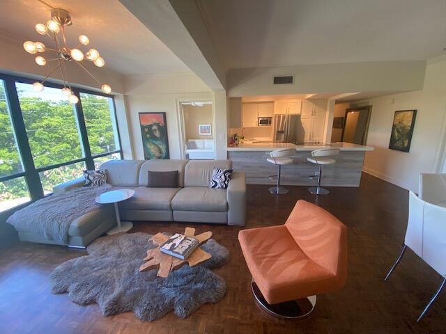 A swimming pool sits on a patio next to a multi-story building overlooking the water — 850 NE Spanish River Boulevard # 33, Boca Raton FL 33431, BOCA RATON, FL
