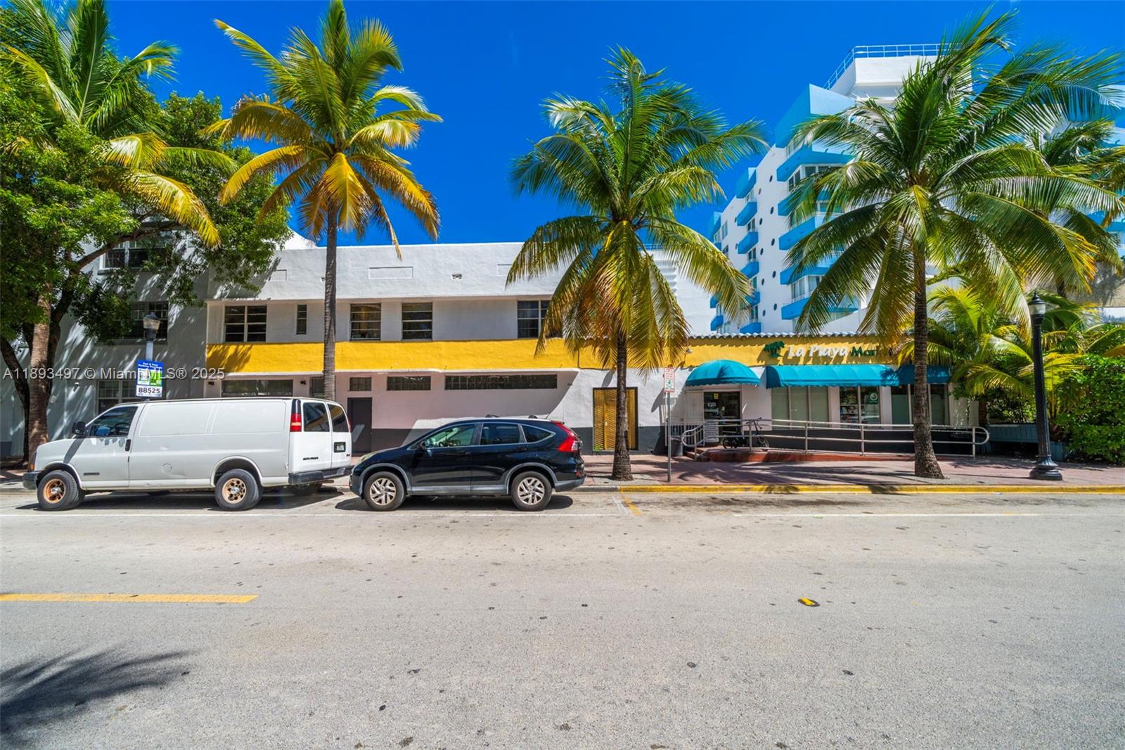 A white van and a black SUV are parked in front of a commercial building — 249 Collins Ave, Miami Beach FL 33139, MIAMI BEACH, FL
